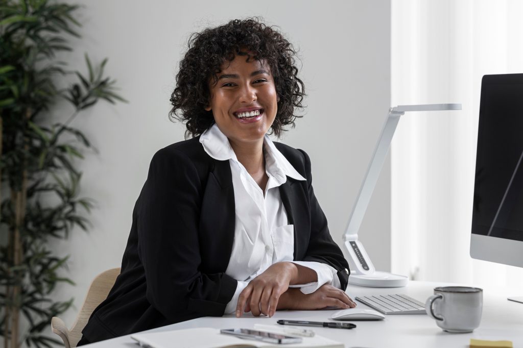 A smiling woman at her office